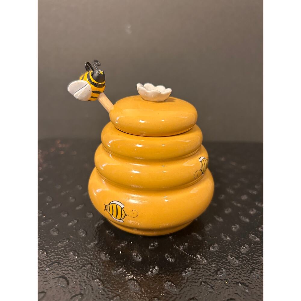 Ceramic honey jar resembling beehive and honey comb